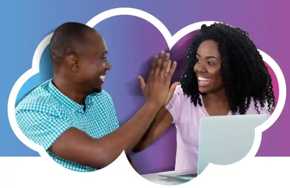 Two colleagues smiling and high-fiving in an office setting.