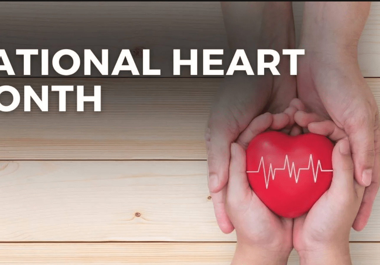 Hands cradling red heart with heartbeat line