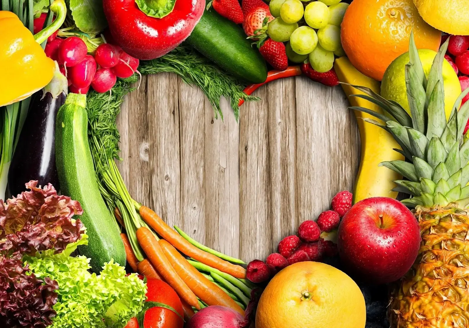 Heart-shaped fresh produce frame on wood